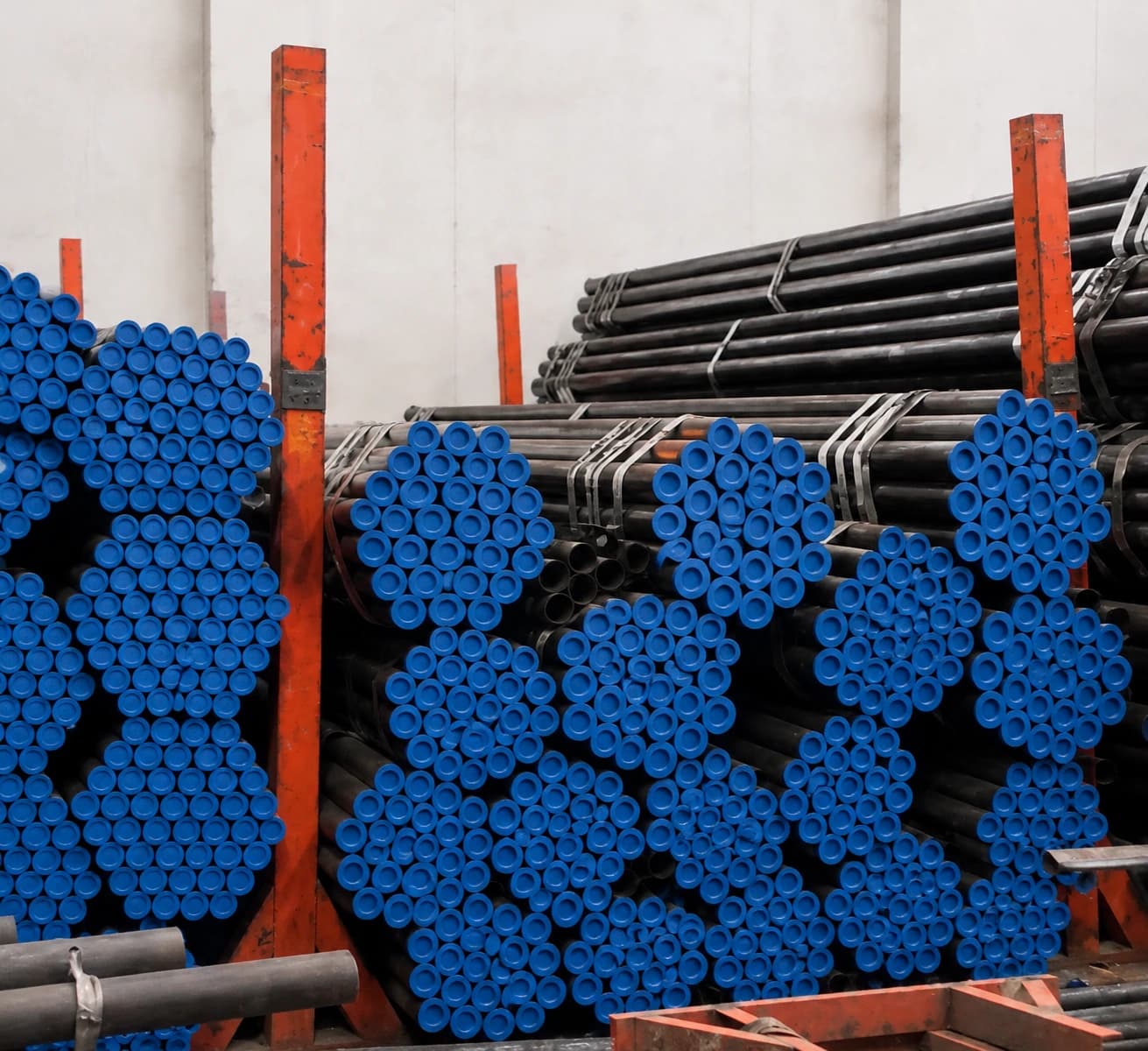 Indus Trading Co. warehouse stacked with capped steel pipes