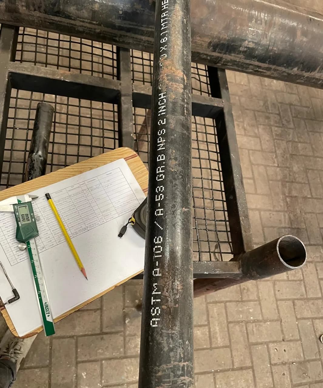 Inspector examining pipes during quality control